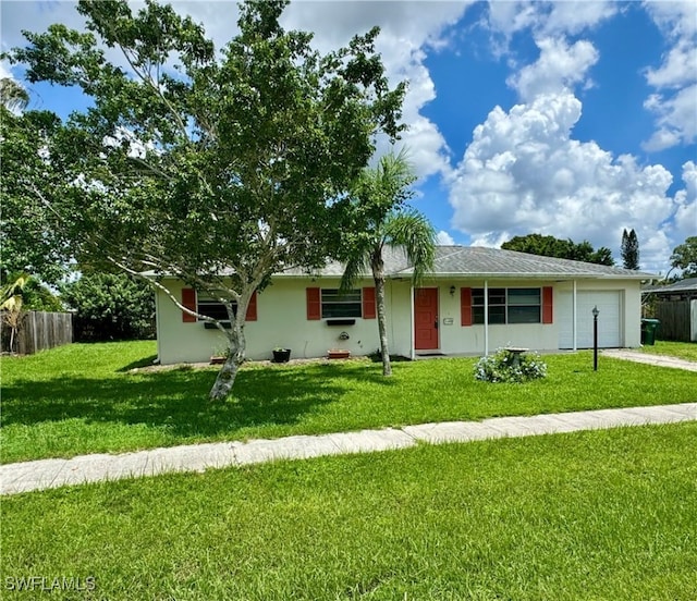 ranch-style home featuring a garage and a front lawn