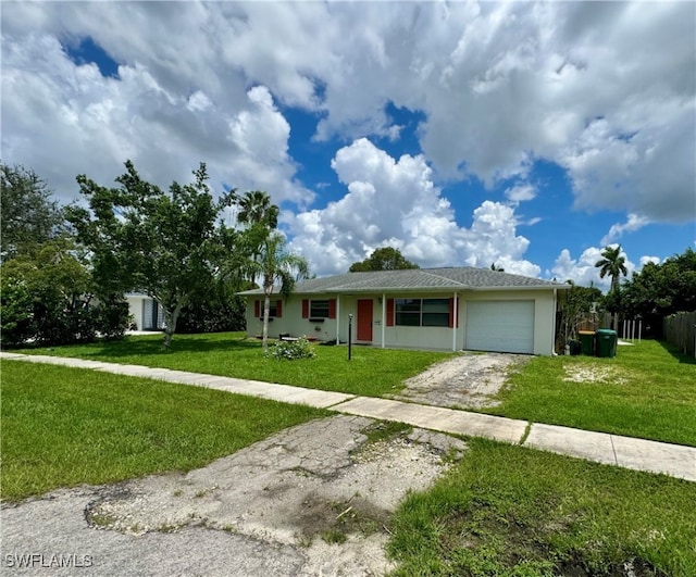 single story home featuring a front yard and a garage