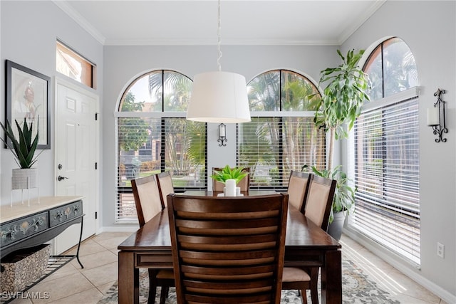 dining space with crown molding and light tile patterned floors