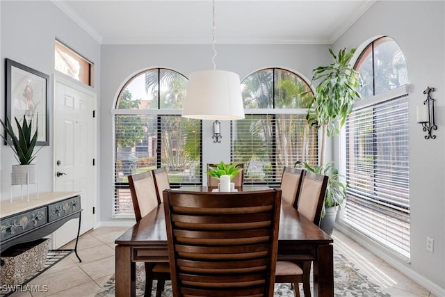 dining space featuring light tile patterned floors and crown molding