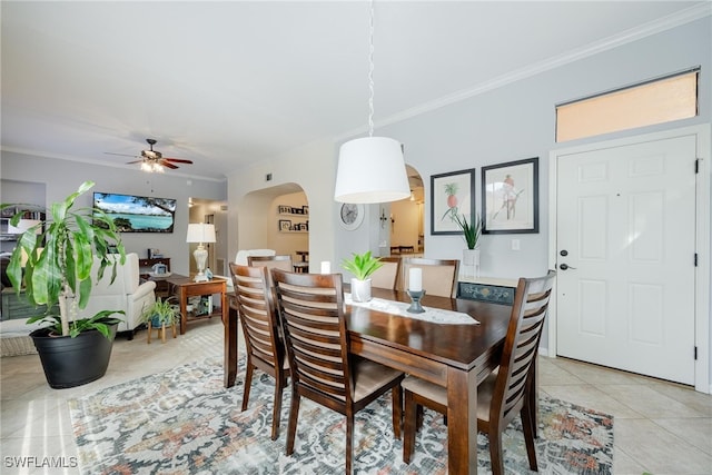 dining space featuring crown molding, ceiling fan, and light tile patterned floors