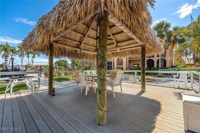 wooden deck with a gazebo and outdoor dining space