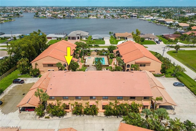 birds eye view of property with a water view and a residential view