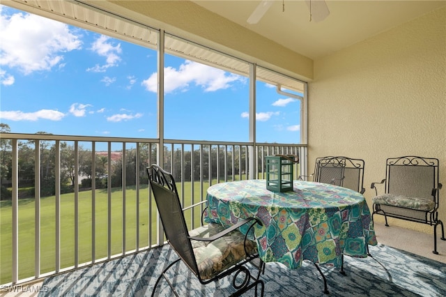 sunroom / solarium featuring ceiling fan