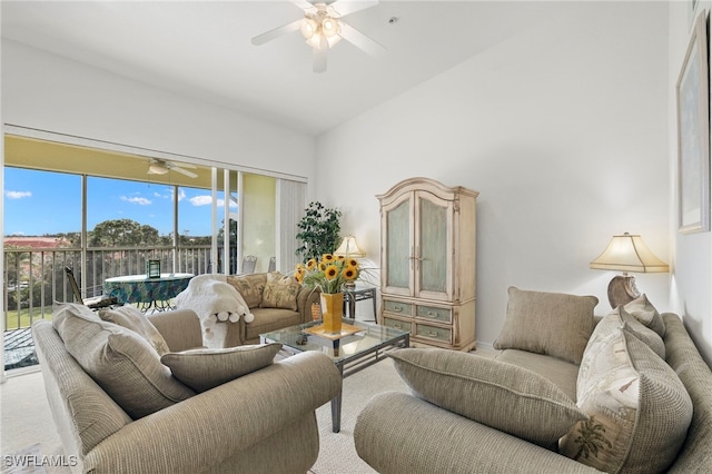 living room with vaulted ceiling, ceiling fan, and carpet