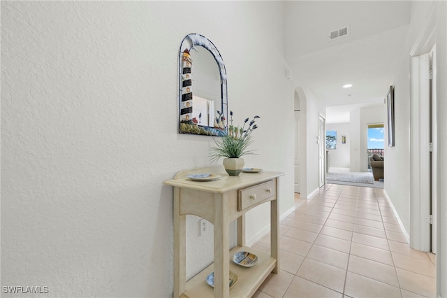 hallway featuring light tile patterned flooring