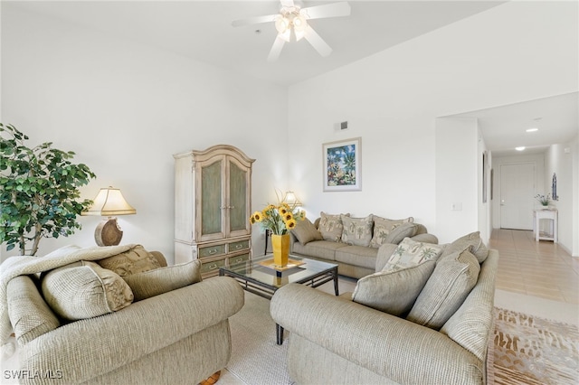 tiled living room with ceiling fan