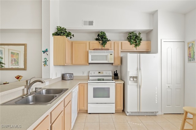 kitchen featuring light tile patterned floors, white appliances, sink, and light brown cabinets