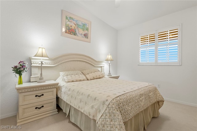 bedroom featuring light carpet, vaulted ceiling, and ceiling fan