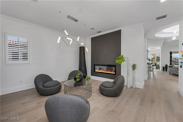 sitting room featuring light hardwood / wood-style floors and ornamental molding