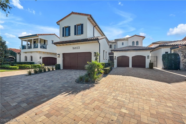 mediterranean / spanish-style house featuring a balcony and a garage