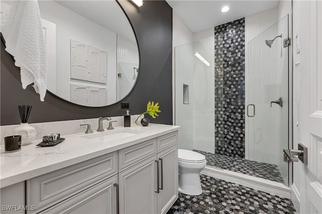 bathroom with vanity, toilet, and an enclosed shower