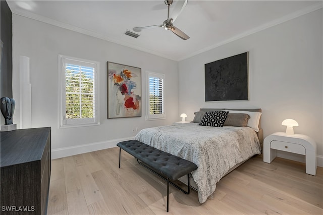 bedroom with light wood-type flooring, ornamental molding, and ceiling fan