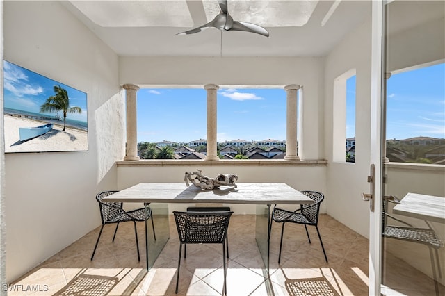 sunroom with a healthy amount of sunlight and ceiling fan