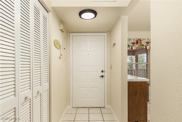 doorway to outside with light tile patterned flooring