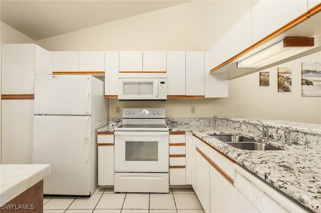 kitchen with lofted ceiling, white appliances, white cabinetry, and light tile patterned flooring