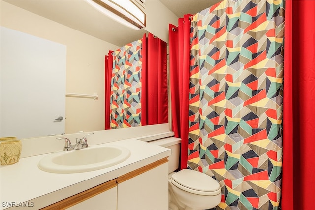 bathroom with toilet and vanity