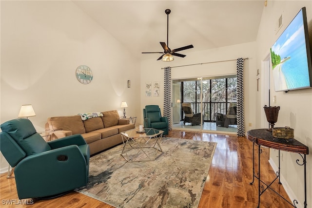 living room with high vaulted ceiling, ceiling fan, and hardwood / wood-style flooring