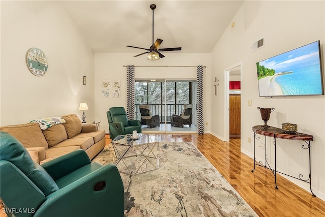 living room featuring high vaulted ceiling, ceiling fan, and light hardwood / wood-style flooring