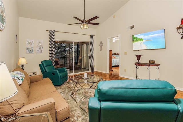 living room featuring ceiling fan, hardwood / wood-style floors, and high vaulted ceiling