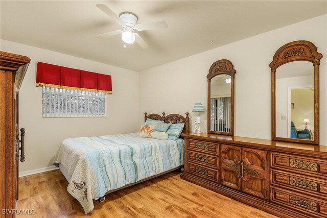 bedroom with ceiling fan and light hardwood / wood-style flooring