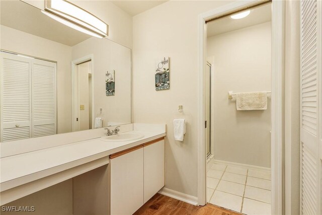 bathroom featuring vanity, an enclosed shower, and tile patterned floors