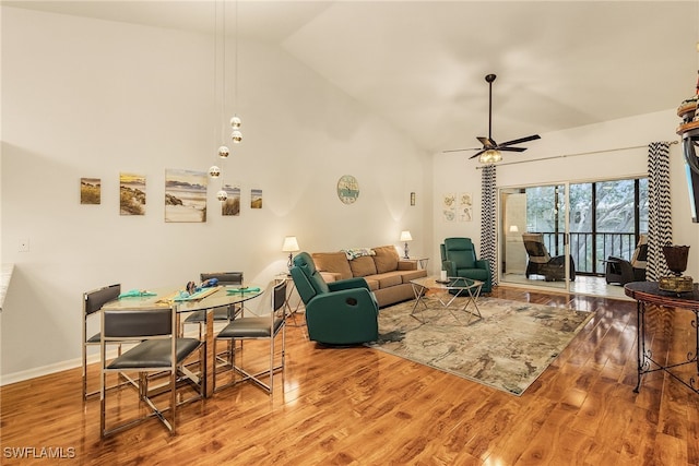 living room with high vaulted ceiling, hardwood / wood-style flooring, and ceiling fan