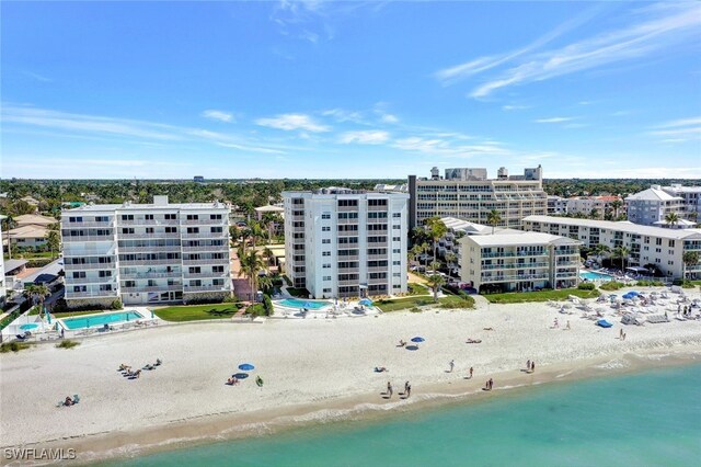 drone / aerial view featuring a view of the beach and a water view