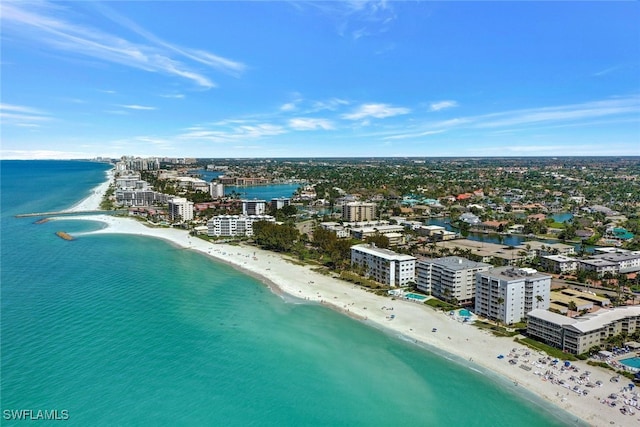 birds eye view of property with a view of city, a water view, and a beach view