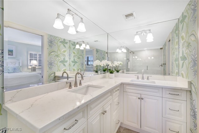 full bathroom with wallpapered walls, visible vents, a sink, and ensuite bathroom