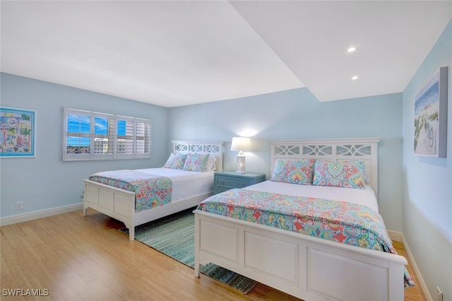 bedroom with recessed lighting, baseboards, and light wood finished floors