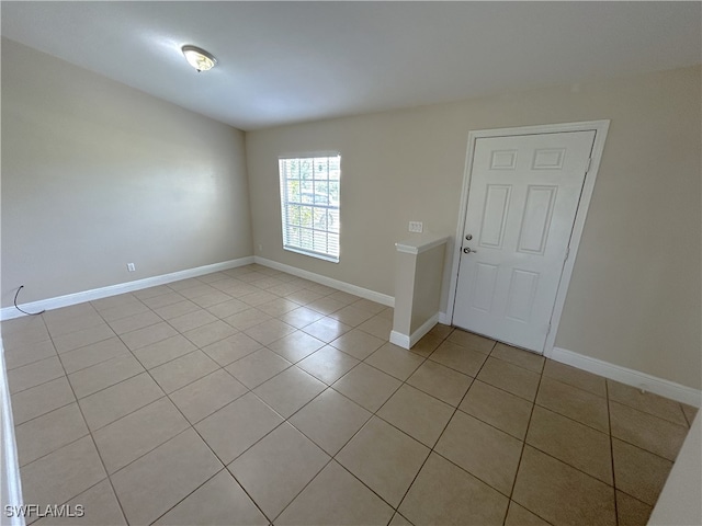 unfurnished room featuring light tile patterned floors