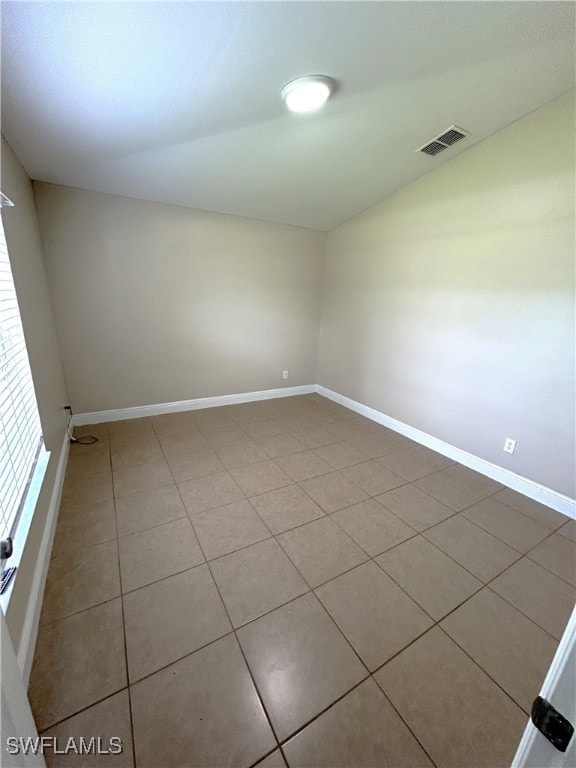 spare room with tile patterned flooring