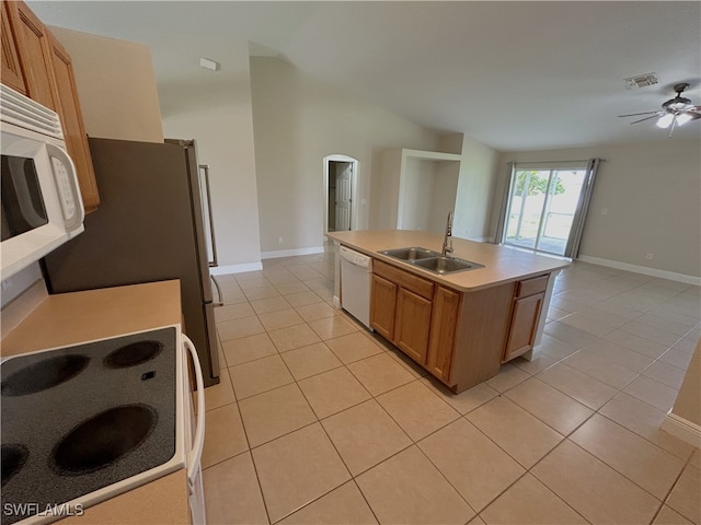 kitchen featuring a center island with sink, light tile patterned floors, ceiling fan, sink, and white appliances