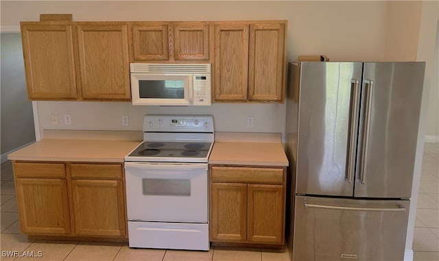 kitchen with white appliances and light tile patterned floors