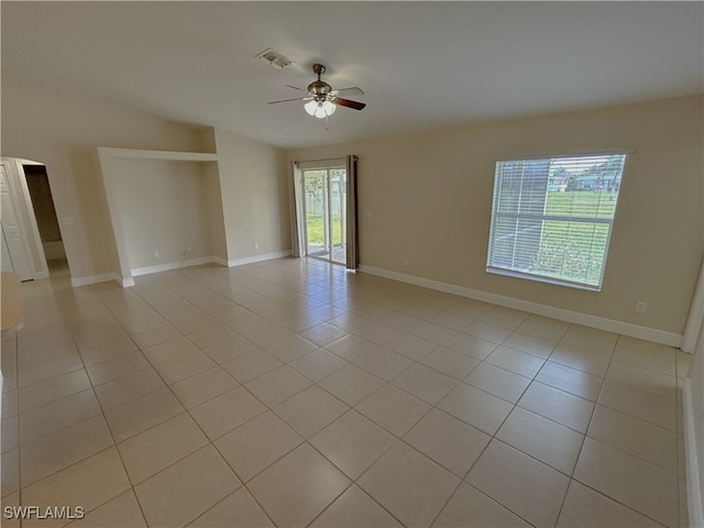 tiled empty room featuring ceiling fan