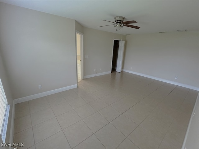 unfurnished room with ceiling fan and light tile patterned floors