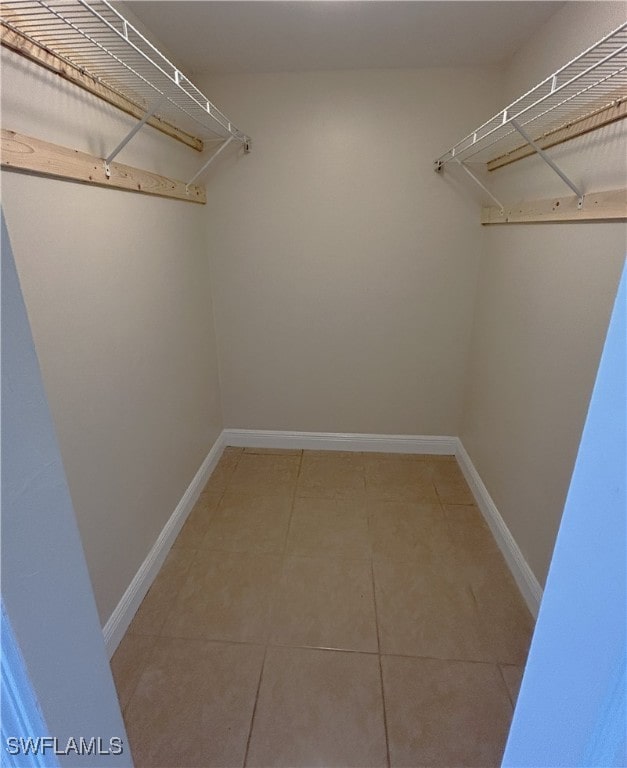 spacious closet featuring tile patterned flooring