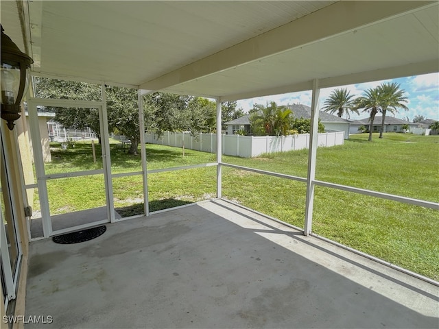 unfurnished sunroom with beam ceiling