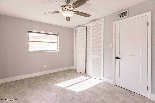 unfurnished bedroom featuring a closet, visible vents, ceiling fan, and baseboards