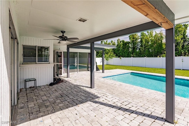 view of pool featuring a lawn, a fenced in pool, a fenced backyard, ceiling fan, and a patio area