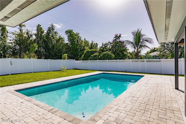 view of pool featuring a patio area, a fenced backyard, a fenced in pool, and a yard