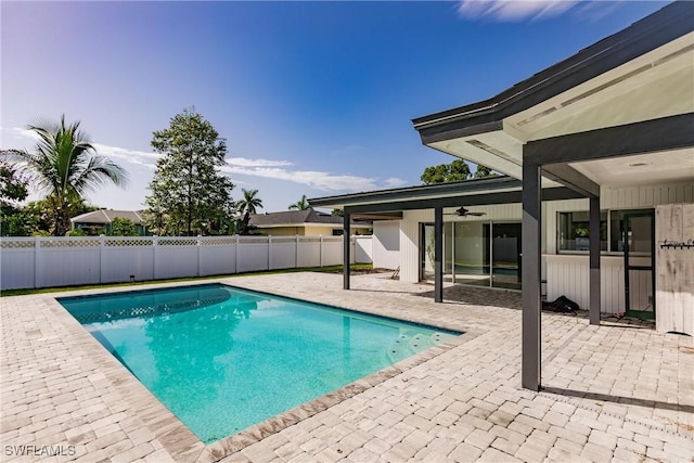 view of swimming pool with a fenced in pool, a fenced backyard, a patio, and ceiling fan