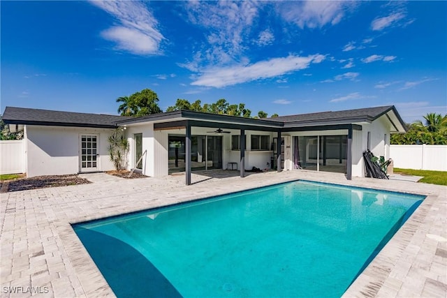 back of property with a fenced in pool, ceiling fan, fence, a patio area, and stucco siding