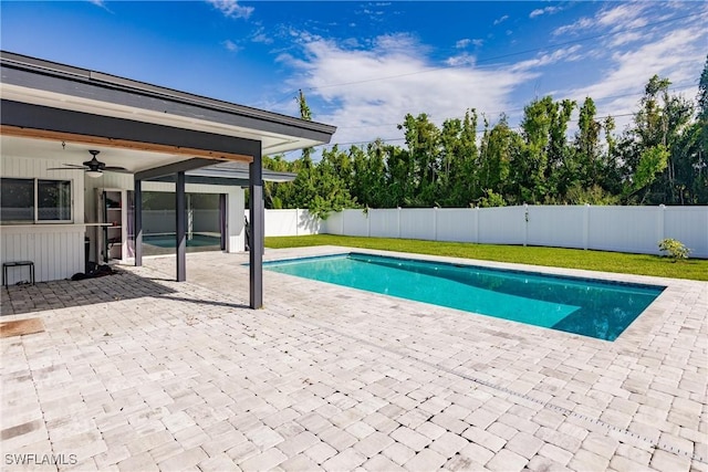 view of pool with a fenced in pool, a lawn, a ceiling fan, a patio area, and a fenced backyard