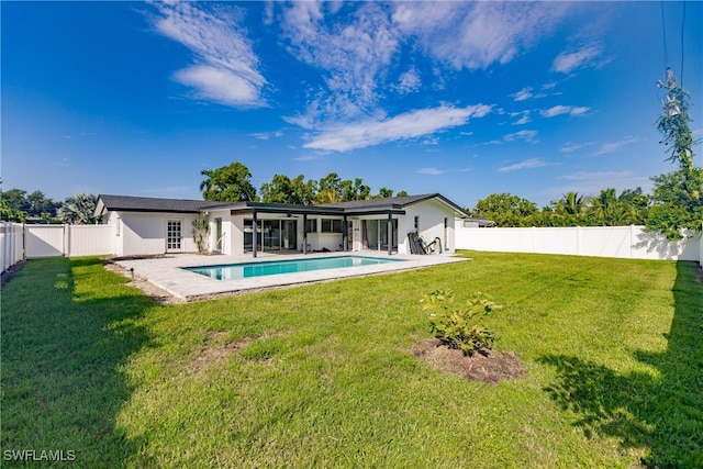 back of property with a patio, a fenced backyard, a yard, a fenced in pool, and stucco siding