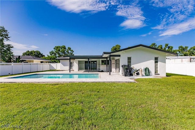 rear view of property with a patio, a fenced backyard, a yard, a fenced in pool, and stucco siding