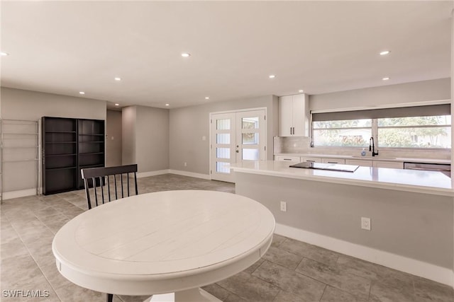 dining space featuring light tile patterned floors, baseboards, and recessed lighting