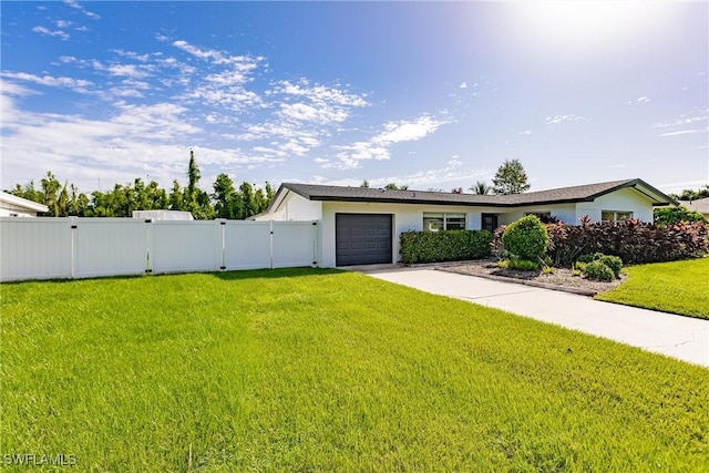 single story home featuring a garage, fence, concrete driveway, a gate, and a front lawn