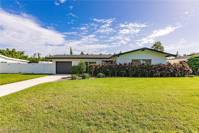 single story home featuring a garage and a front lawn